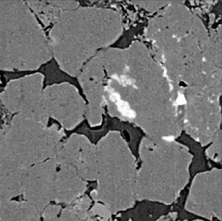 Grayscale XRM image of irregular granular particles with dark pore gaps