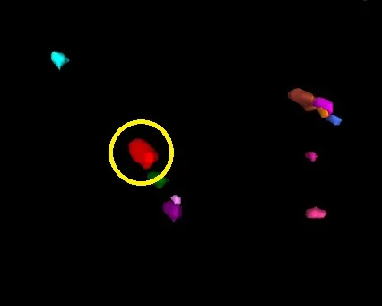 Black background with several colored 3D blobs and a yellow circle highlighting a red blob
